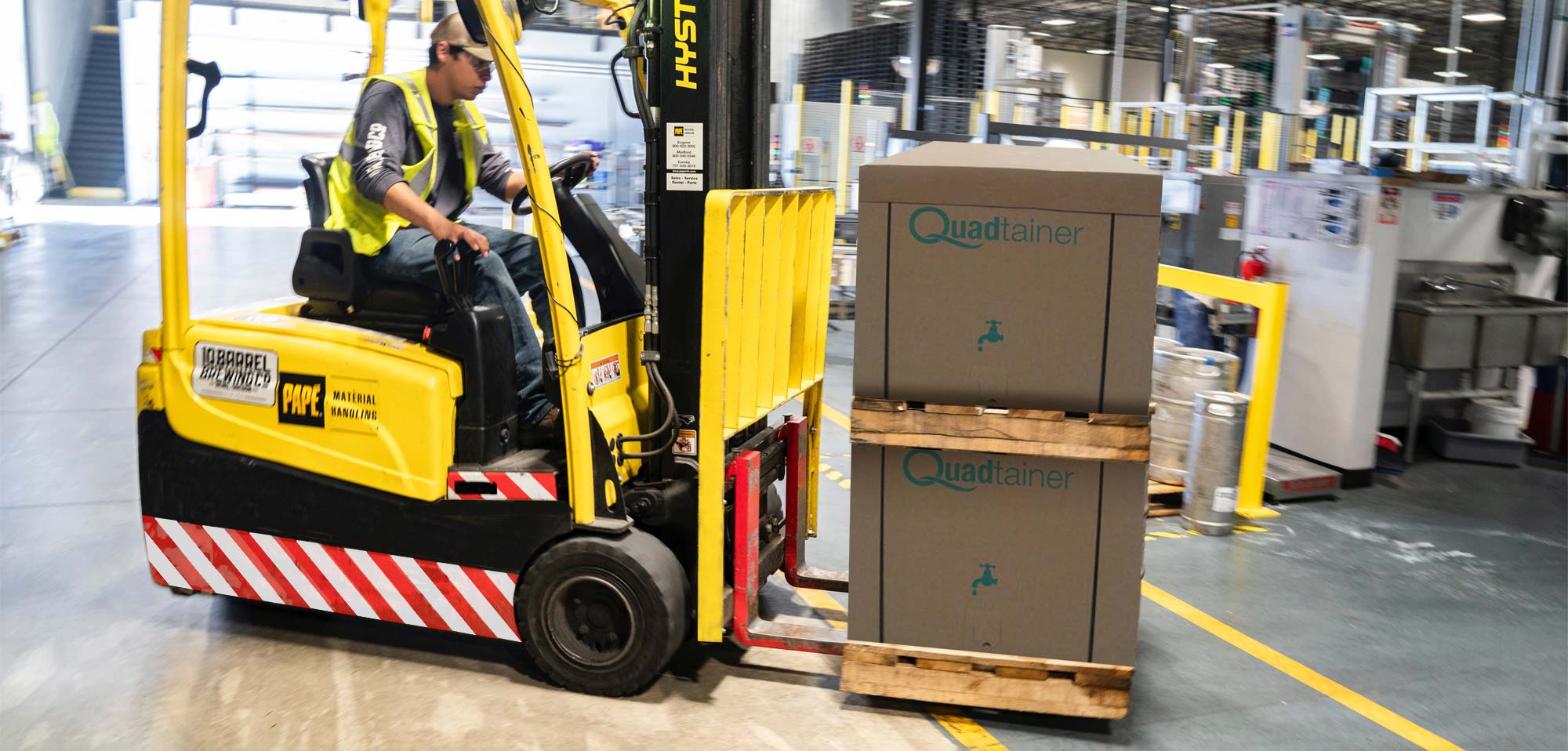 Forklift moving palletised corrugated cases inside the Donpack production facility